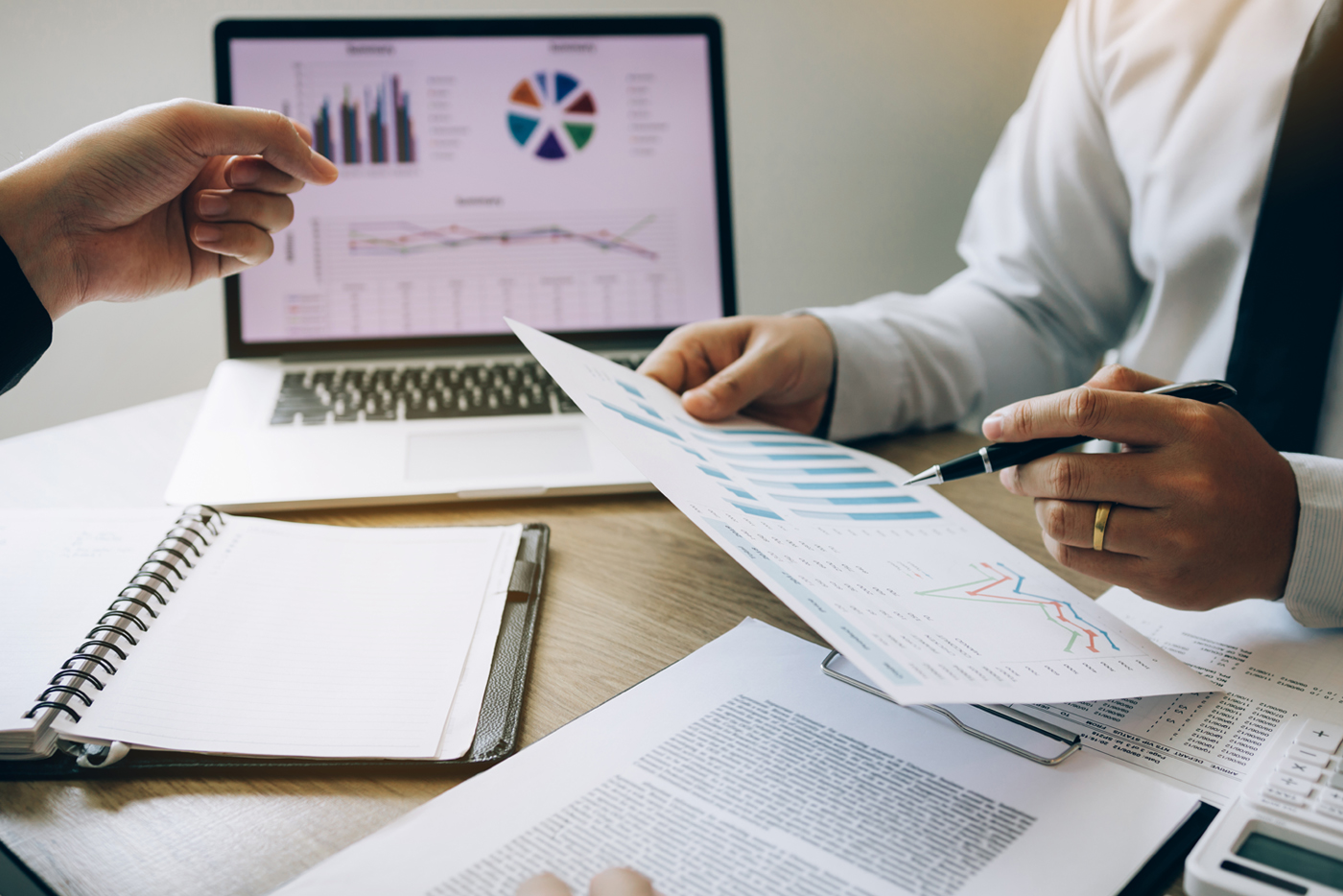 Two businessmen are jointly analyzing the financial budget and c